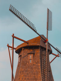 Low angle view of crane against sky