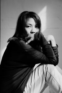 Close-up portrait of young woman at home