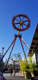 Low angle view of ferris wheel against clear sky