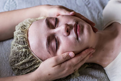 Close-up of woman getting face massage at spa