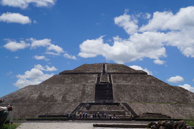 Low angle view of pyramid at teotihuacan against cloudy sky