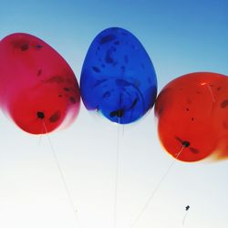 Low angle view of balloons against blue sky