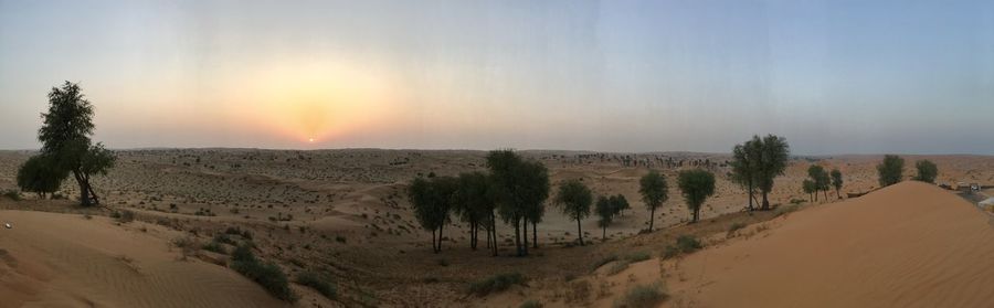 Panoramic view of desert against sky during sunset