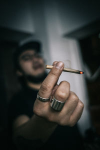 Midsection of man smoking cigarette