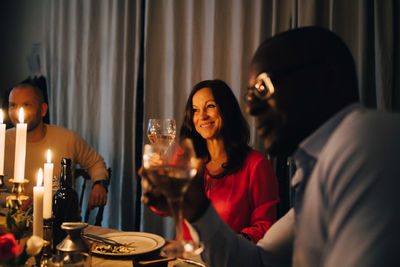 Friends drinking wine at dinner party