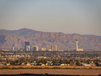 City by mountains against clear sky