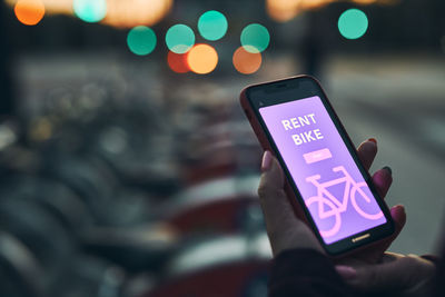 Renting bike using rental app on mobile phone. using bike sharing city service. mobile payment app