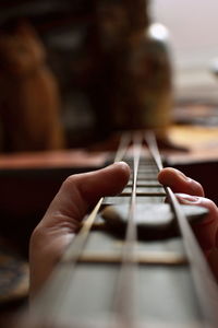 Close-up of hand playing guitar