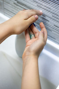 Close-up of woman washing hands