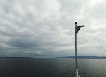 Seagull flying over sea against sky