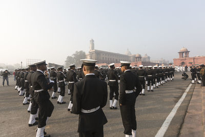 Rear view of people in row against clear sky