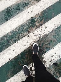 Low section of man standing on cobblestone