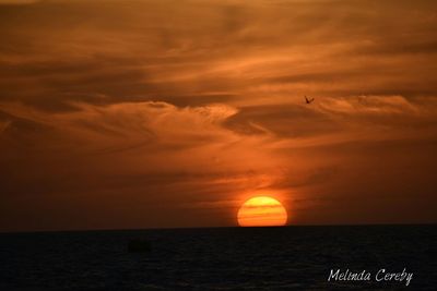 Scenic view of sea against orange sky