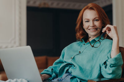 Portrait of smiling woman using mobile phone