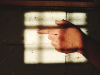 Close-up of human hand on wall