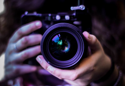 Midsection of woman holding camera