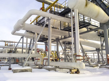 Low angle view of industry at amusement park during winter
