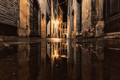 Abandoned building by lake at night