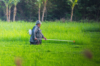 Man with umbrella on field