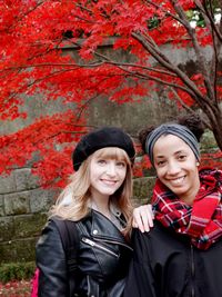 Portrait of female friends standing at park