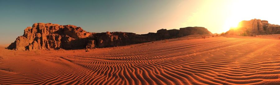 Scenic view of desert against sky during sunset