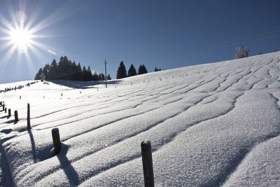 Scenic view of snow covered field against clear sky