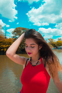 Beautiful young woman standing in water