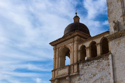 Low angle view of cathedral against cloudy sky