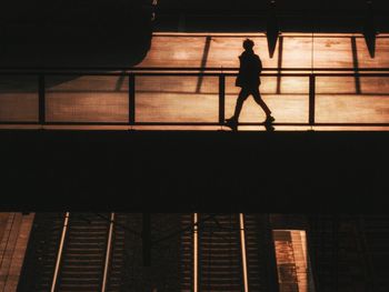 Silhouette people walking in city