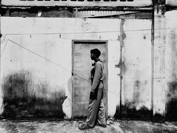 Man standing by old building