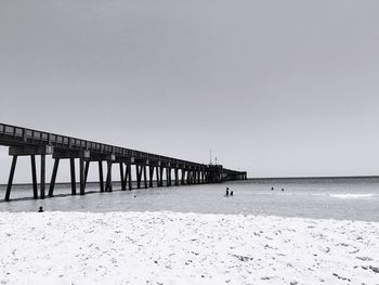 Long jetty on calm beach