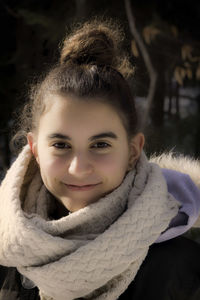 Portrait of girl in warm clothing smiling outdoors
