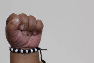 Close-up of person hand over white background