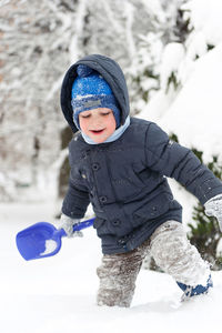 Full length of cute boy in snow