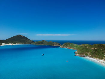 Scenic view of sea against clear blue sky