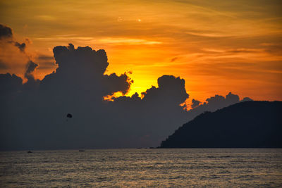 Scenic view of sea against orange sky