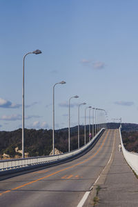 Street light on highway against sky