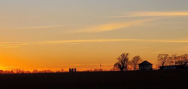 Silhouette buildings against sky during sunset