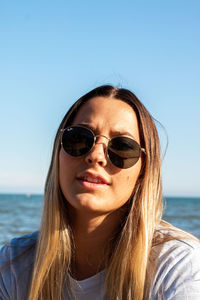 Portrait of beautiful woman against sea