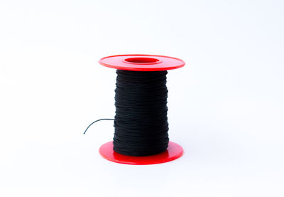 Close-up of thread spool against white background