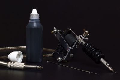 High angle view of bottles on table against black background
