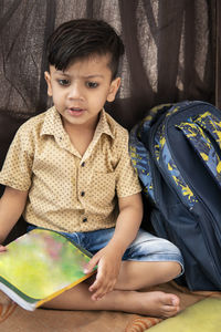 Cute boy sitting at home