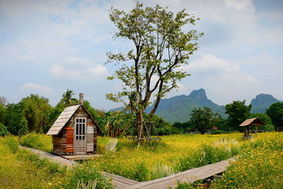 Scenic view of trees and houses against sky