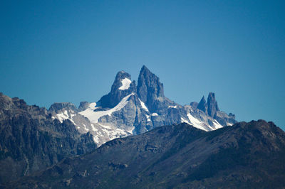 Scenic view of snowcapped mountains against clear blue sky