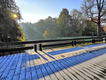 Footpath by railing against sky