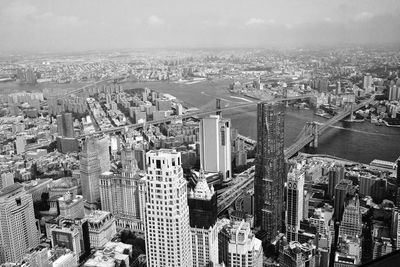 High angle view of brooklyn bridge over east river against sky in city