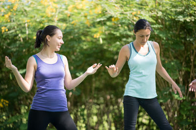 People doing yoga in park