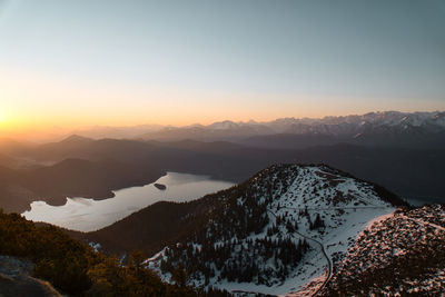 Scenic view of snowcapped mountains against sky during sunset