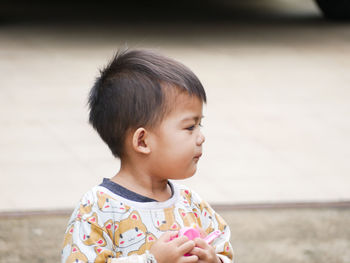 Close-up of cute boy looking away