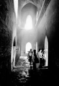 People in illuminated tunnel